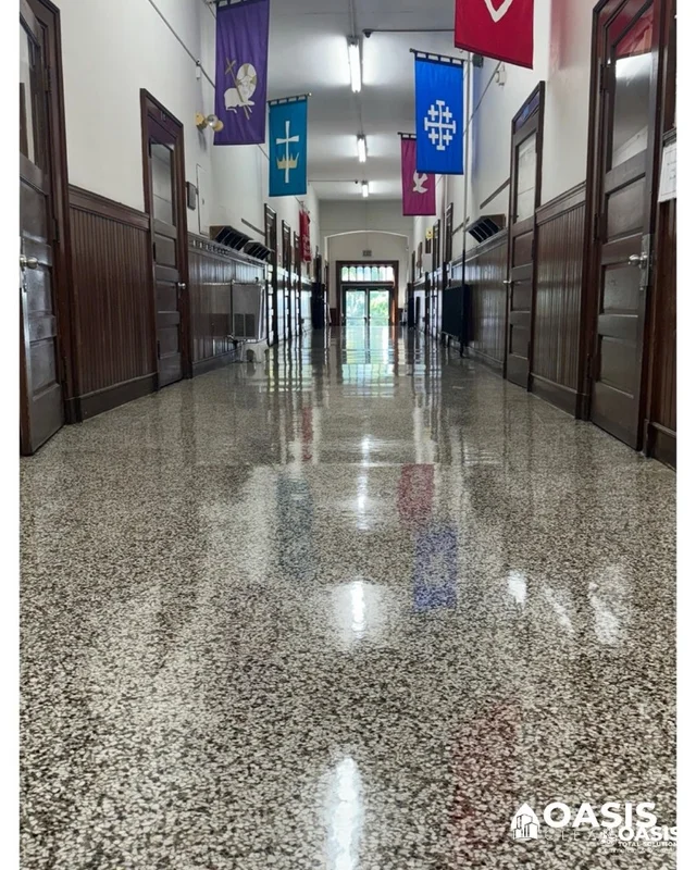 Polished commercial hallway floor reflecting overhead lights