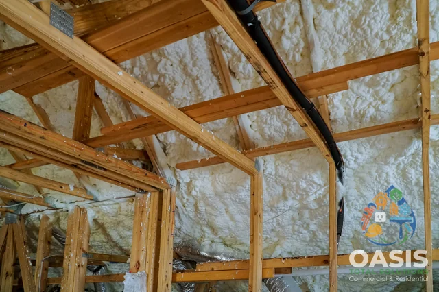 Spray foam insulation applied at roof with wood framing