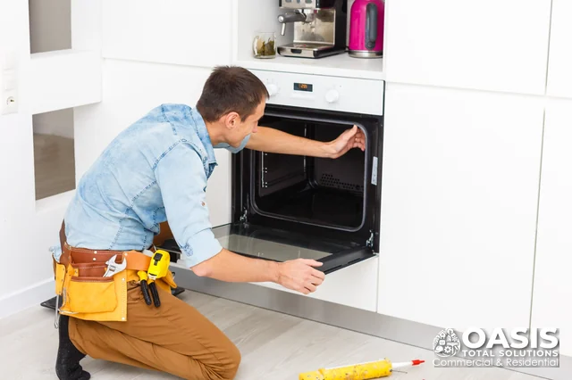 Technician checking a built-in wall oven