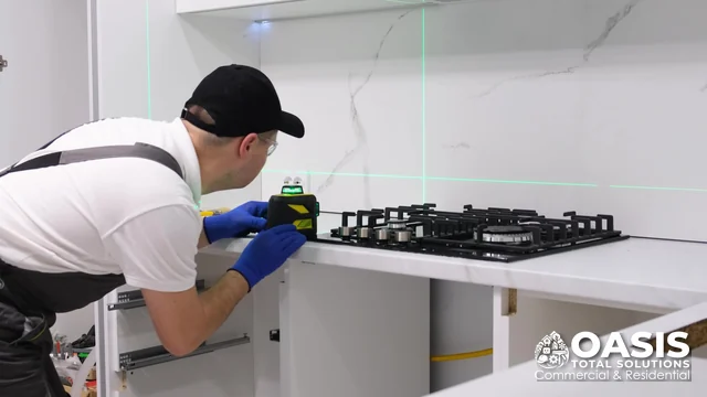 Leveling a gas cooktop with a laser