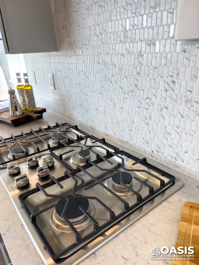 Close-up of gas cooktop and backsplash