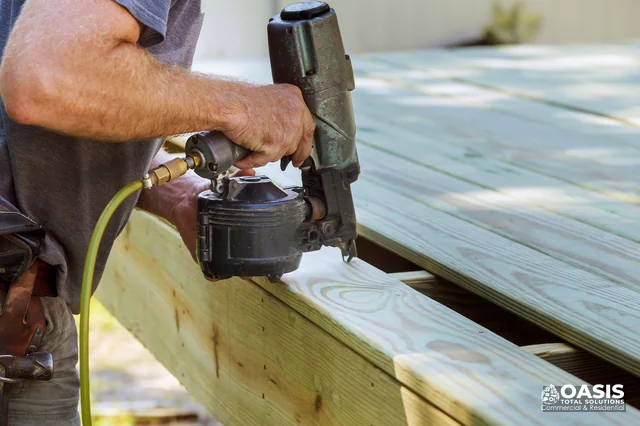 Contractor fastening deck boards with a framing nailer