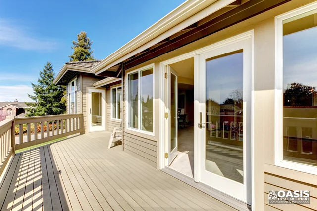 Sunny deck outside sliding doors with railing