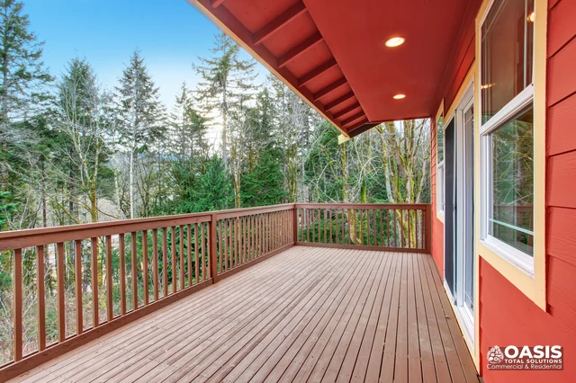 Deck with railing and forest backdrop