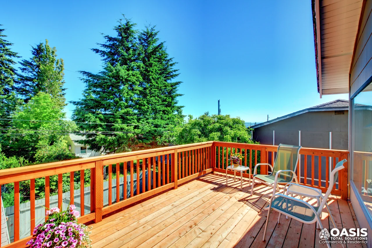 Completed wood deck with lounge chairs and privacy railing