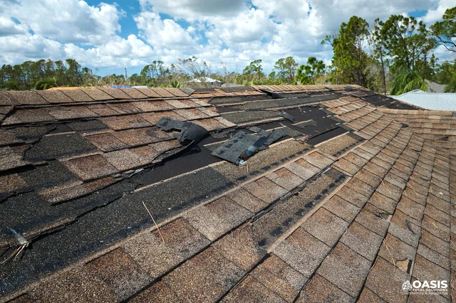 Residential roof with broken and missing shingles