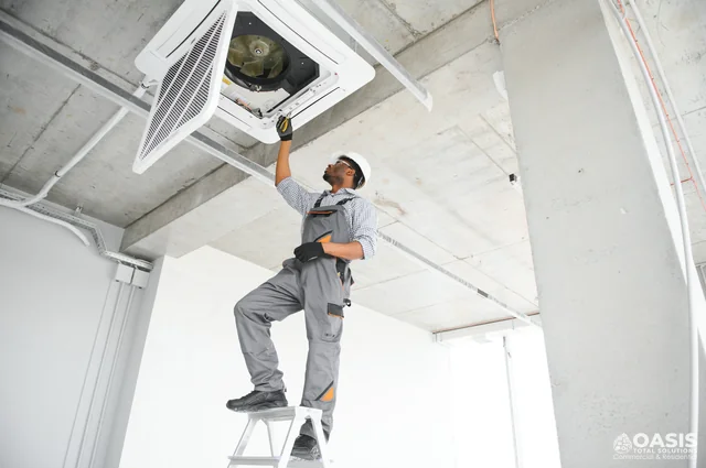 Technician inspecting ceiling cassette