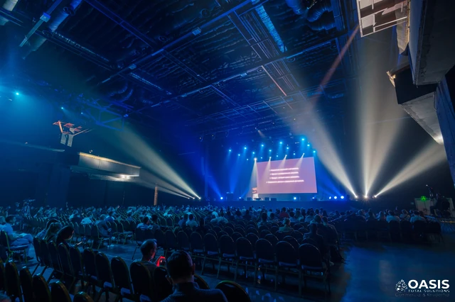Conference hall with stage lighting and audience