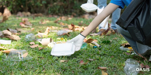 Volunteer picking up litter in a park
