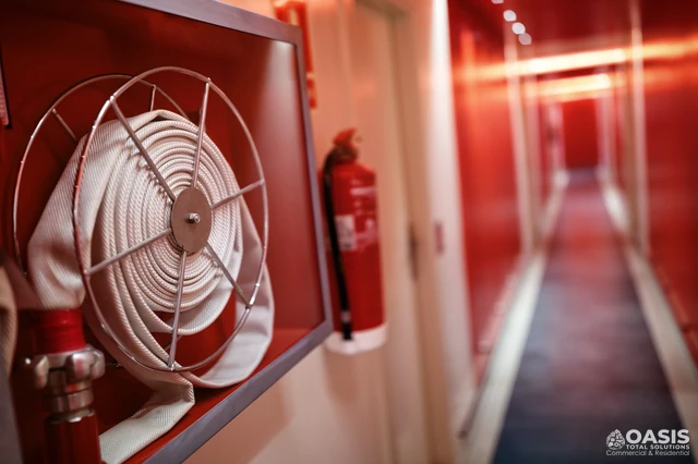 Fire hose reel and extinguisher cabinet in a red corridor