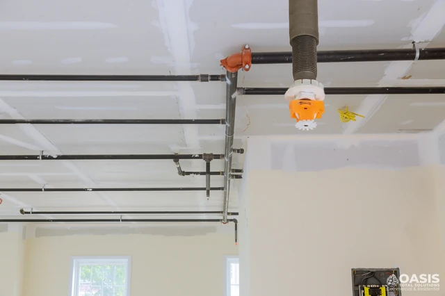 Ceiling fire sprinkler piping with sprinkler head during build-out