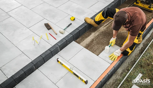 Installing patio stones with level and tools