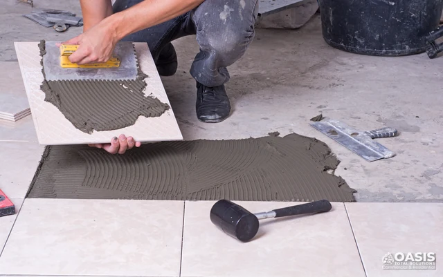 Back-buttering floor tile with thinset mortar