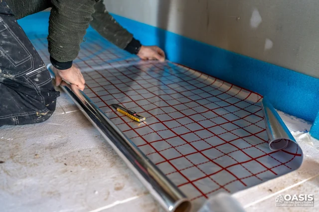 Rolling out radiant/thermal underlayment membrane