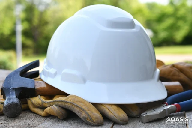 Hard hat with tools on a jobsite table