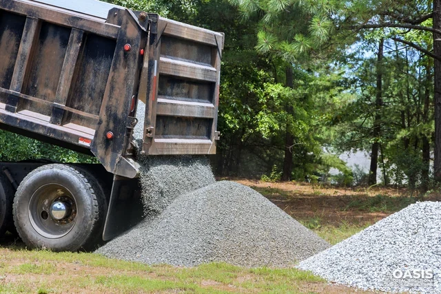 Dump truck delivering gravel on site