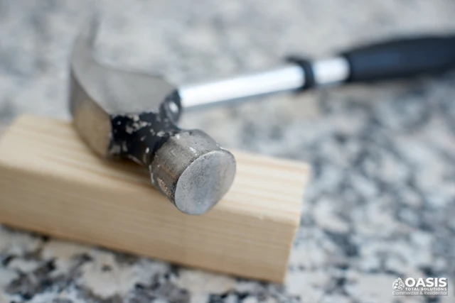 Close-up of hammer and wood on workbench