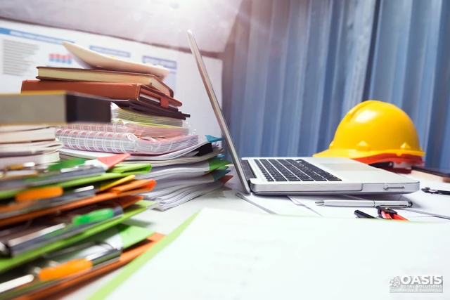 Construction office desk with plans and hard hat