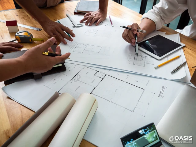 Team reviewing blueprints and measurements