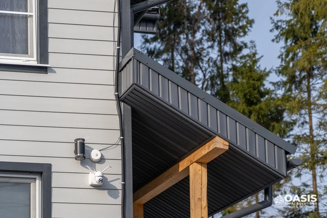 Modern metal soffit and gutter on gray siding