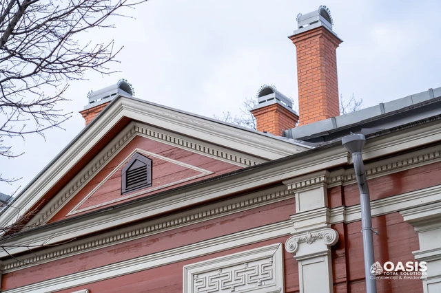 Decorative cornice with metal gutter and downspout on historic home