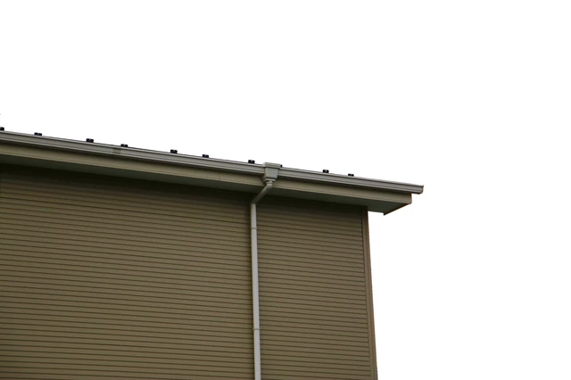 Seamless gutter and downspout on tall exterior wall
