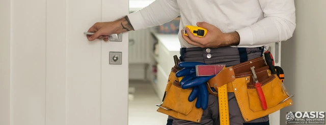 Handyman checking interior door handle alignment