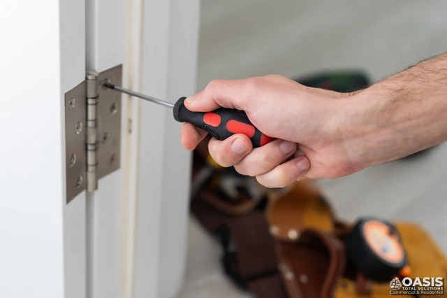Tightening door hinge screws with a hand screwdriver