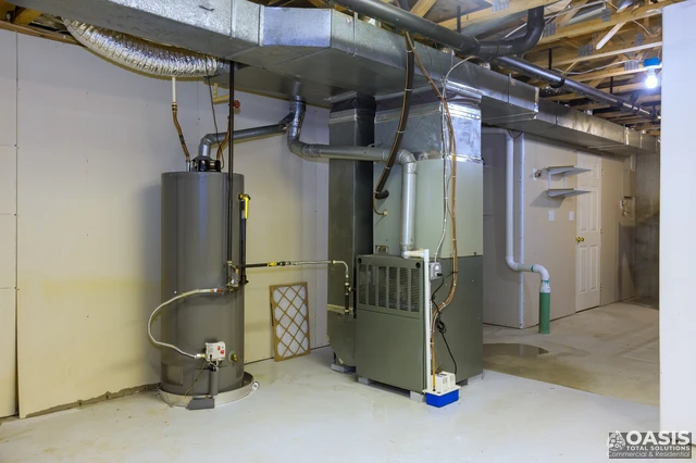 HVAC furnace and water heater in a basement mechanical room