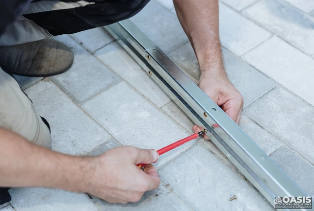 Fastening a metal threshold/track to pavers