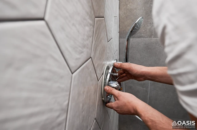Adjusting shower valve trim on tiled wall