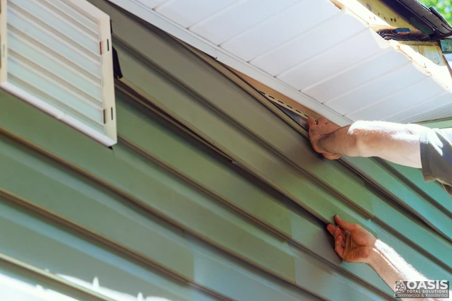 Locking the final course of vinyl siding under the soffit