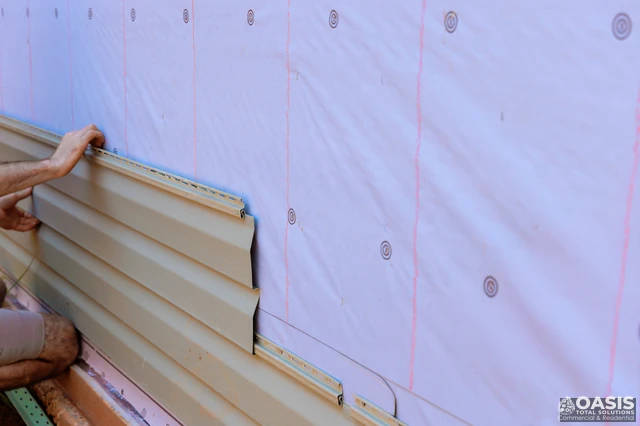 Installing vinyl siding starter strip over house wrap