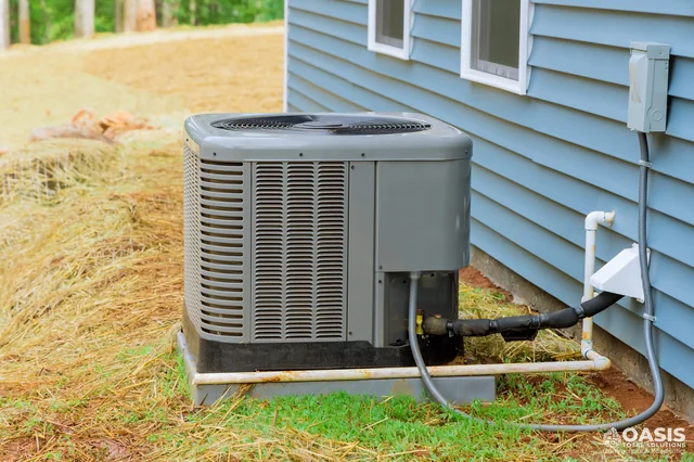 Outdoor AC unit by blue siding