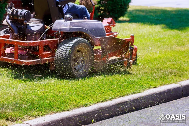Mower discharging clippings at curb