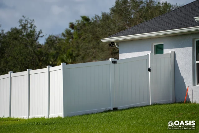 White vinyl fence and gates by house