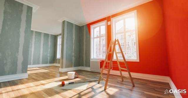 Ladder and tools in a room with a fresh red accent wall