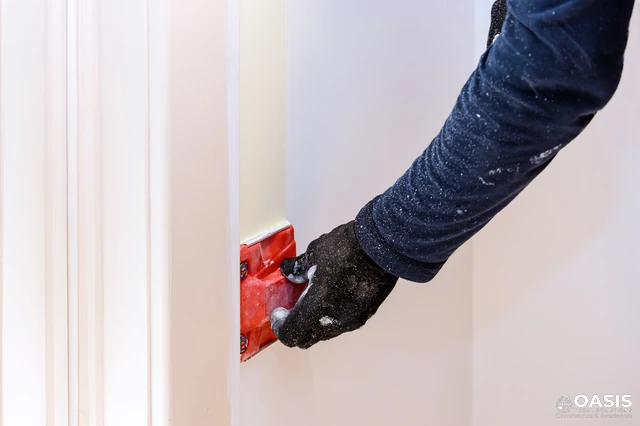 Using a paint edger along a door frame