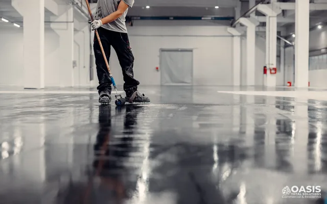 Technician rolling epoxy coating on a concrete floor