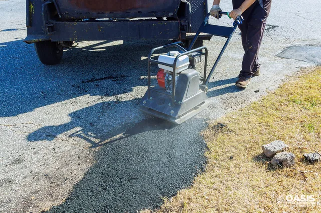 Compacting a fresh asphalt patch with a plate compactor