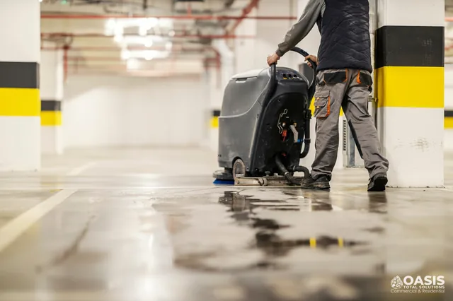Auto scrubber cleaning a parking garage floor