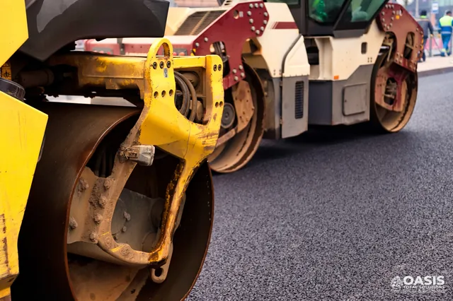 Road roller compacting a new asphalt surface