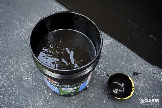 Sealcoat bucket ready for application on asphalt