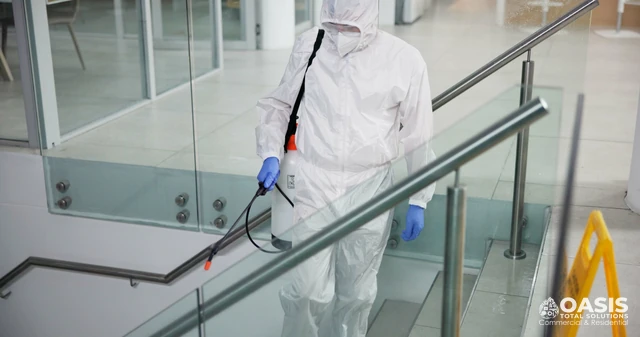 Commercial stairwell treatment by technician in protective gear