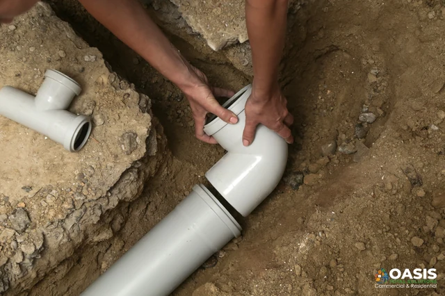 Installing PVC drain elbow in trench