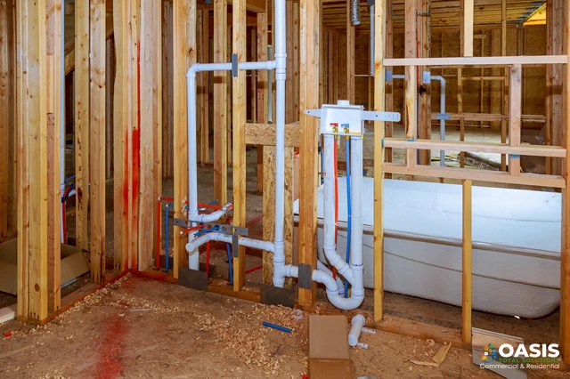 DWV rough-in and tub set within framed walls