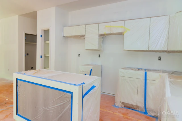 Kitchen covered and taped off before paint and finish work