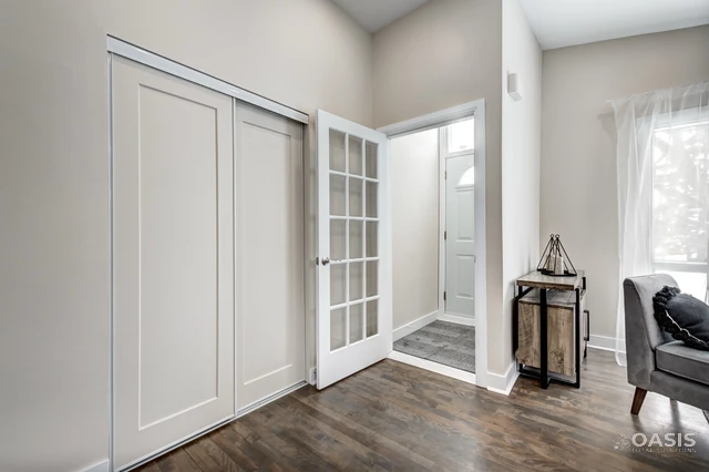 Renovated entry with sliding closet doors and glass-panel interior door