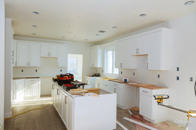 Bright kitchen during install with tools on island