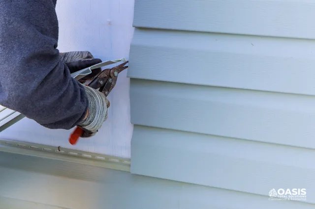 Trimming vinyl siding at the inside corner with snips